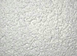 Scheibenputz mit Kratzputzeffekt (Macroaufnahme)